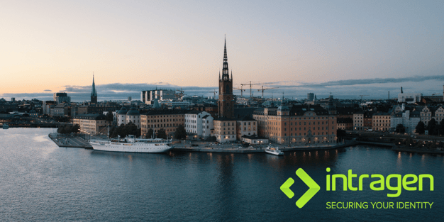 A photograph of Stockholm from the sea. A church  spire is centred with surrounding buildings and the sunsetting sky above and sea below. The green Intragen logo is in the bottom right corner.