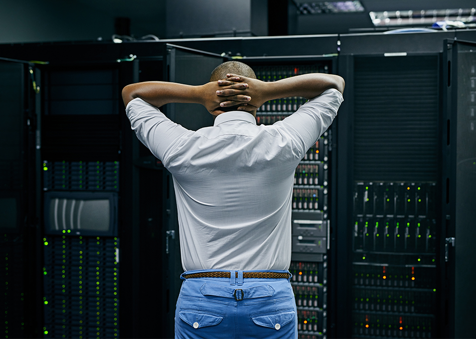 950x677 - Man standing in front of a computer server