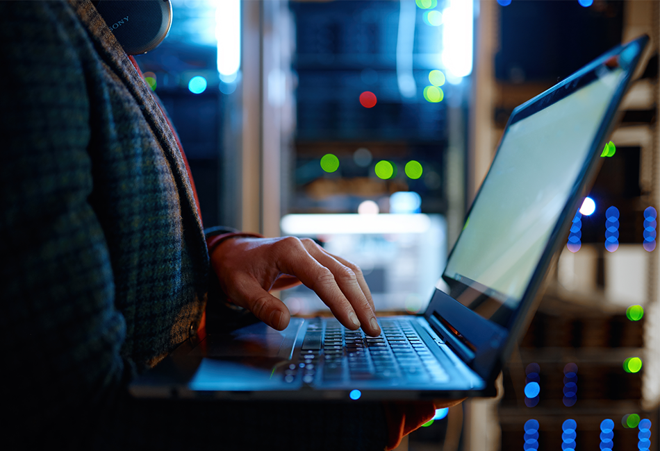 Person on computer in a server room