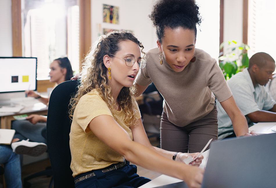Women discussing a computer screen